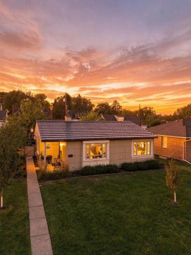 A warm evening view highlights the homeâs simple, enduring design.