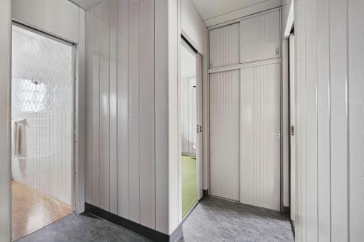 The hallway connects the living spaces with the same original architectural detailing.