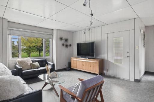 Large windows bring natural light into the living room throughout the day.