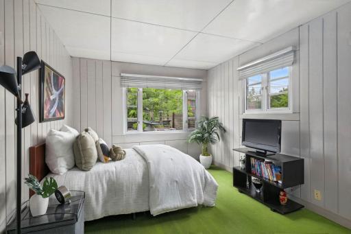 The bedroom continues the homeâs distinctive steel-panel design with windows on two sides.