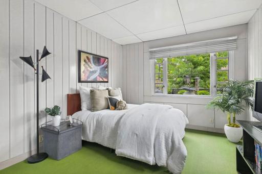A 2nd bright bedroom with simple lines and preserved architectural character.