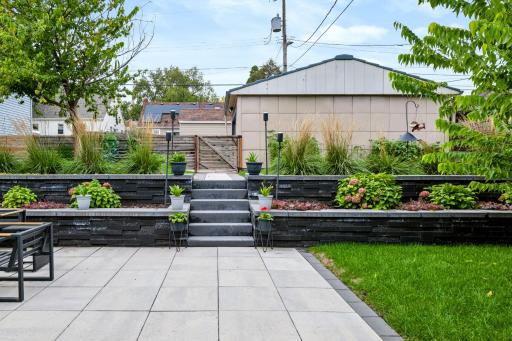 Terraced landscaping creates structure, color, and visual interest throughout the backyard.