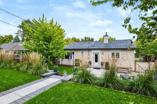 A large patio extends the living space outdoors with room for dining and entertaining.