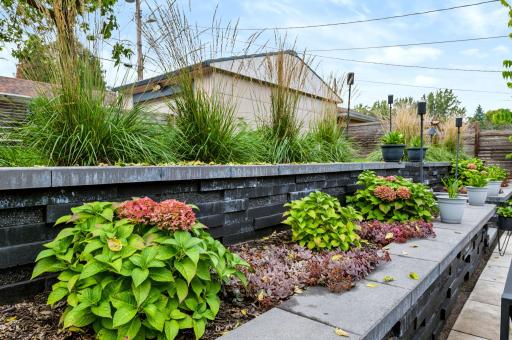 Layered plantings and retaining walls create a beautifully composed garden setting.