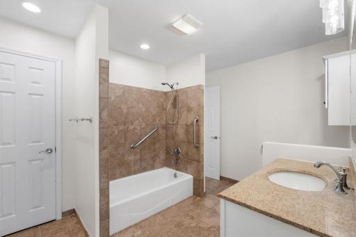 Updated main-floor bathroom featuring a custom tiled shower and modern finishes.