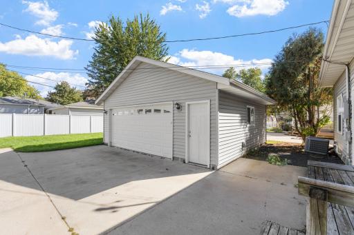 Rear view highlighting the garage, private driveway parking, and fully usable lot.