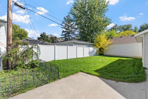 Fully usable private backyard featuring open lawn space and mature greenery.