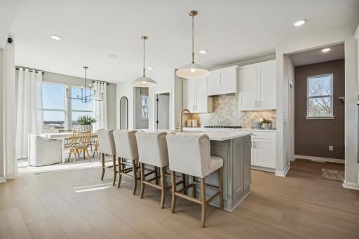 Expansive island with quartz surface offers additional prep space, bar seating, and a stylish centerpiece to your new kitchen.