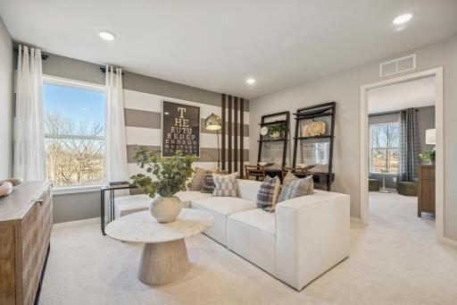 Loft’s open layout connects effortlessly to surrounding rooms, providing a bright and inviting upper-level retreat.