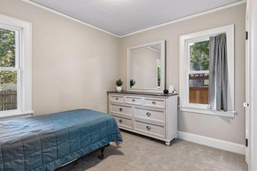 Second main-level bedroom with natural light, neutral finishes, and flexible space for a bedroom, guest room, or home office.