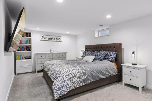 Finished lower-level family room offers additional living space and is currently used as a bedroom.