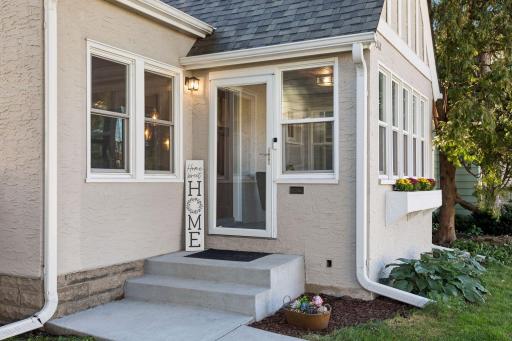 Inviting front entrance with classic architectural details and convenient access to the three-season front porch.