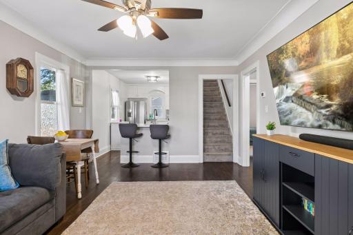 Open view from the living and dining areas toward the modern kitchen, highlighting the functional main-level floor plan and hardwood floors.