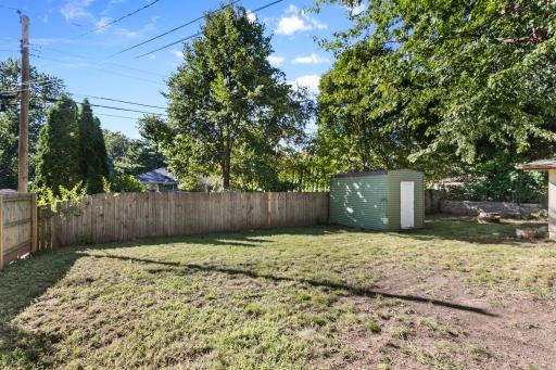 Fully fenced back yard with 12x8 storage shed.