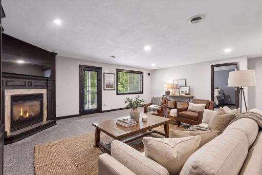 A corner gas fireplace, recessed lighting, and built-in Bose speakers create an inviting setting for movie nights and entertaining. The lower level also features convenient motion-sensor lighting and a built-in gun safe located in the hallway.