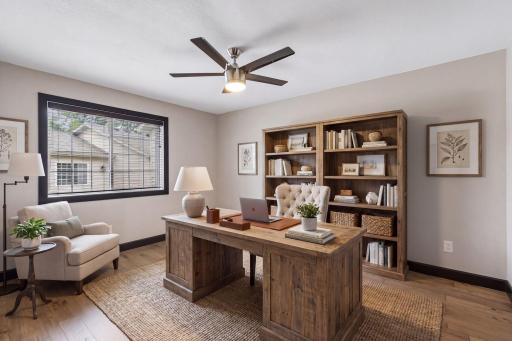 A second view of the main-level bedroom shows a flexible space that can serve as a guest room or home office.