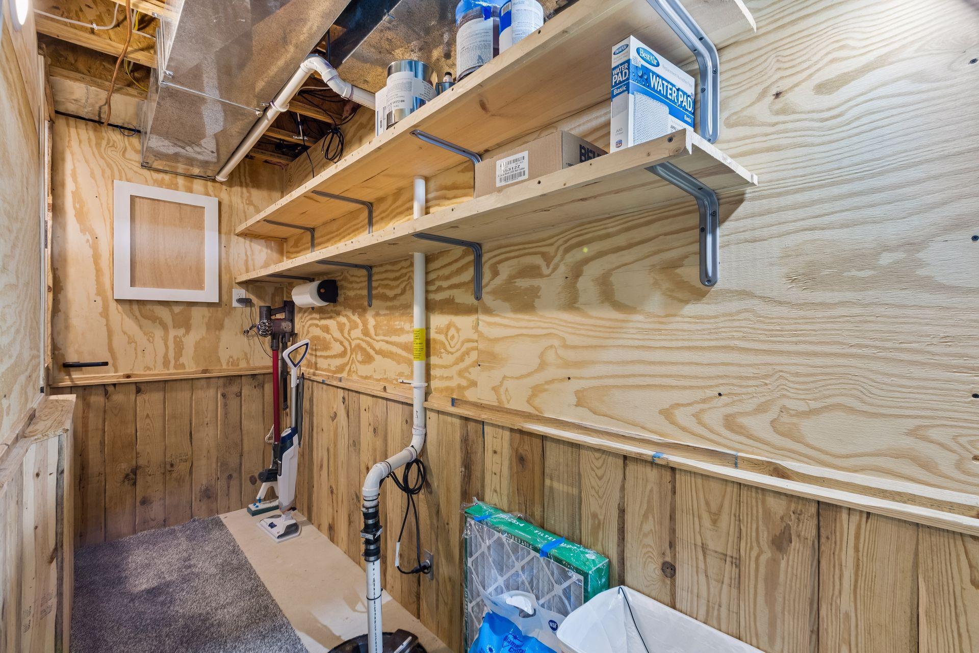This lower-level area houses the mechanicals and offers more storage, with built-in shelving and a convenient utility sink.