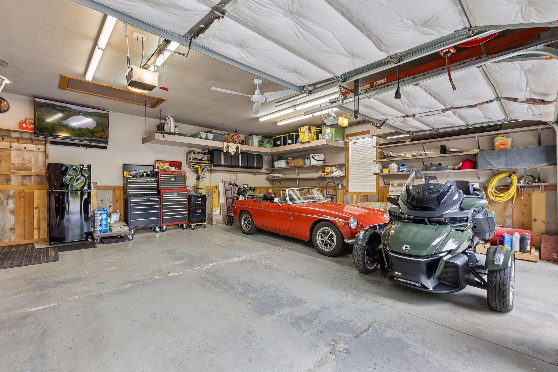 The finished two-car garage is ideal for car enthusiasts or hobbyists, with heat and air conditioning, extensive shelving, and custom organization. There's even enough room for all the toys!