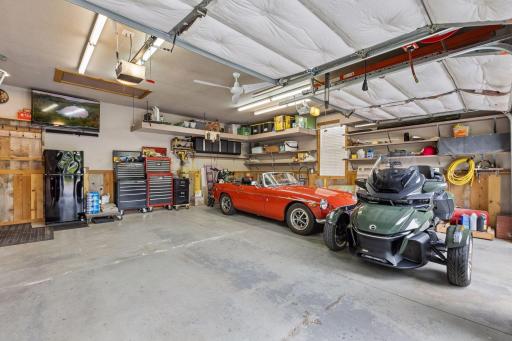 The finished two-car garage is ideal for car enthusiasts or hobbyists, with heat and air conditioning, extensive shelving, and custom organization. There's even enough room for all the toys!