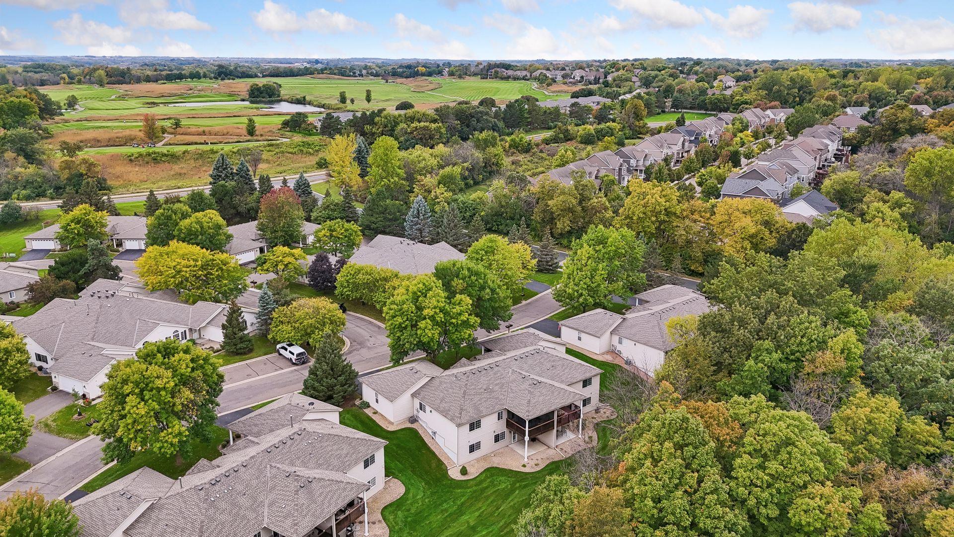 An elevated view highlights the home’s attractive Chaska setting, surrounded by mature trees, expansive green space, and nearby recreational amenities.