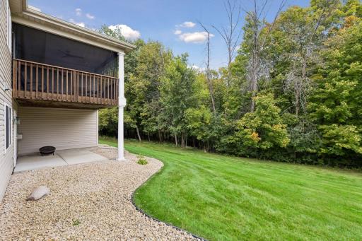 The homeâs premium setting offers expansive green space, mature trees, and a peaceful wooded backdrop.