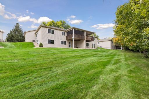 Enjoy a generous stretch of maintained green space bordered by mature trees for a quiet, natural setting.