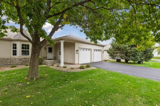 The attractive exterior features mature shade trees, easy-care landscaping, a covered entrance, and an attached two-car garage.