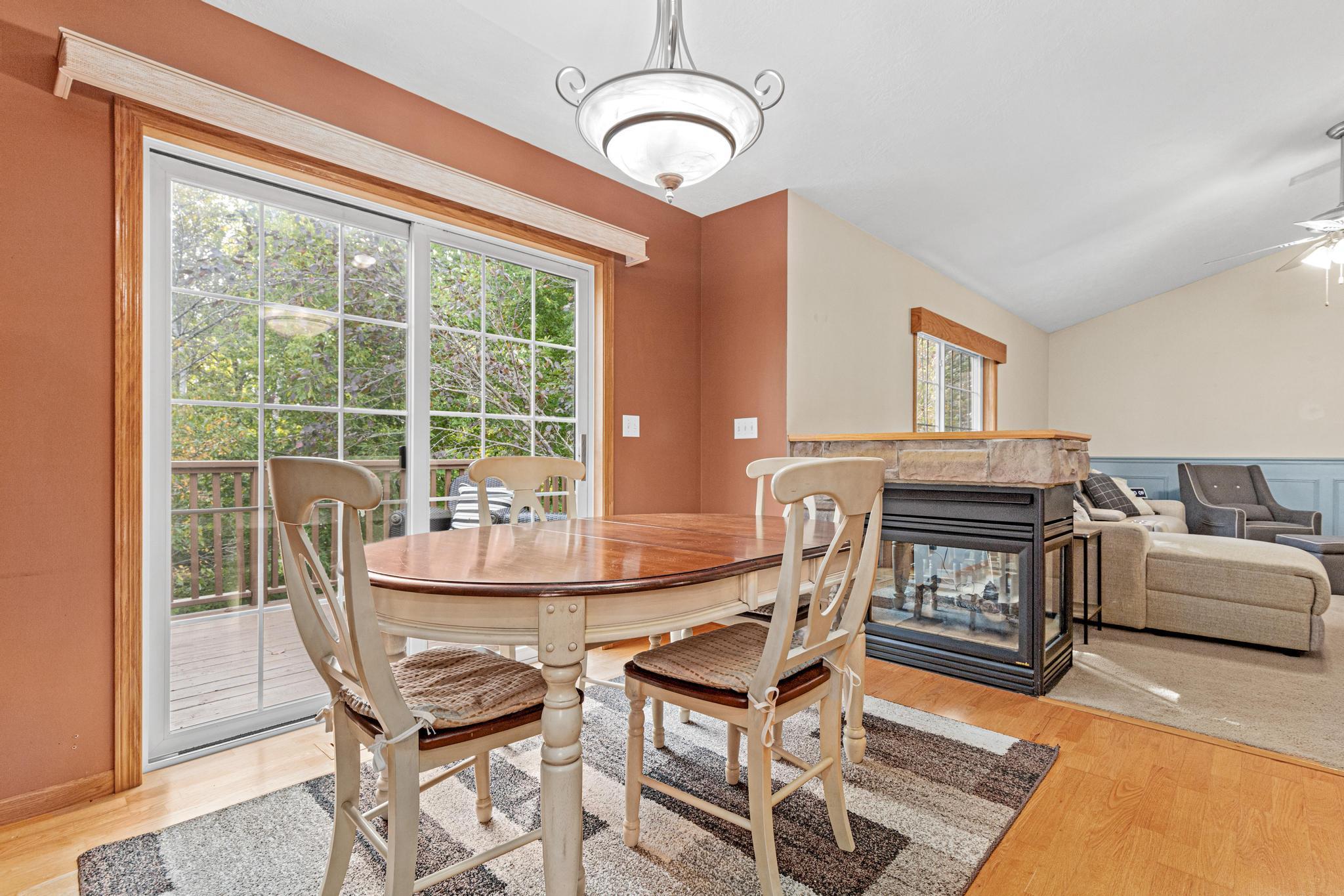 Double sided gas fireplace along with your sliding glass door going out to the deck.