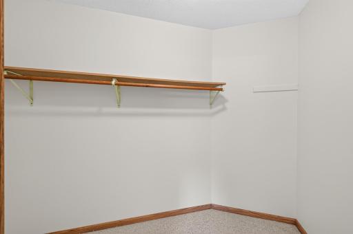 Primary bedroom walk-in closet provides convenient storage for all your personal belongings.