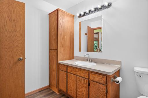Plenty of countertop and cabinet storage makes the full bath both practical and functional.