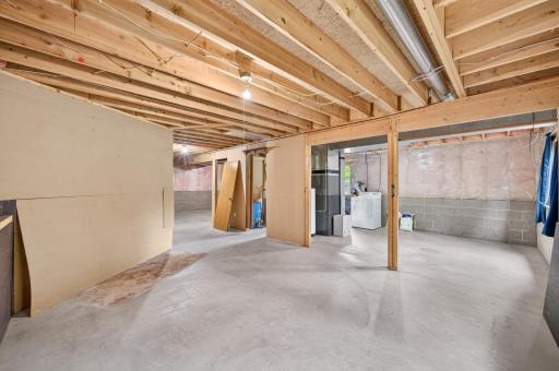 The unfinished lower level is ready for storage, hobbies, or future finishing ideas.