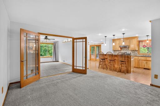 Double doors connect the living room to a versatile bonus room.