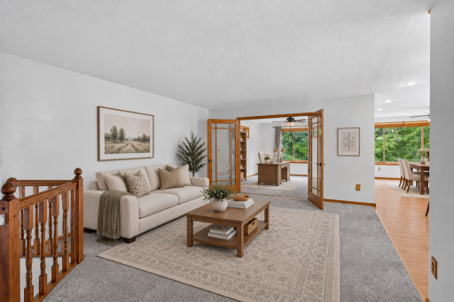 Virtually staged to showcase the inviting living room and its comfortable layout.