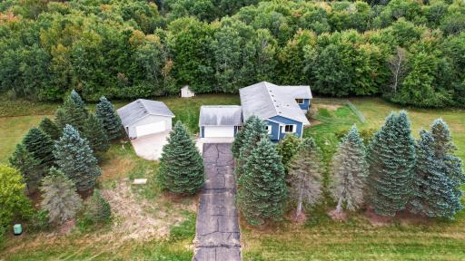 A long driveway leads into the property with a 2-stall attached garage and 2-stall detached garage.
