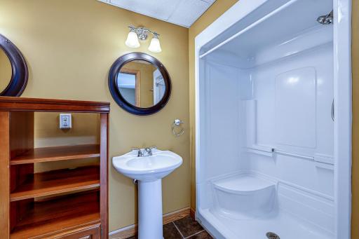 The walk-in shower features a shower seat.