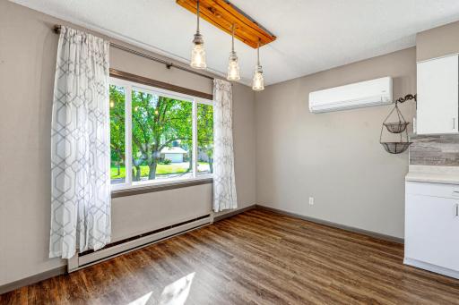 The dining room features a large window with a view of the front yard.