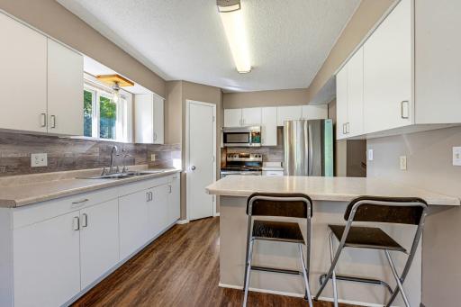The kitchen features a corner pantry closet, S.S. appliances, and additional seating at the counter.