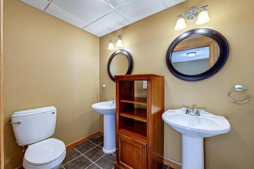 The private ensuite 3/4 bathroom features two sinks.