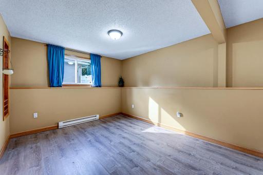 The private primary bedroom is tucked away on the lower level, complete with its own dedicated 3/4 ensuite bathroom and a walk-in closet.