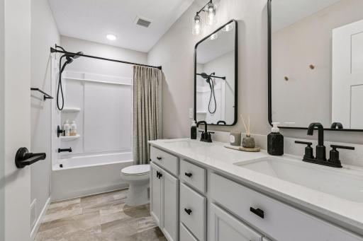 Upper level full bathroom with dual sinks.