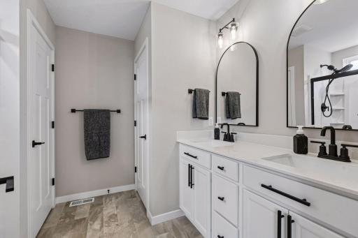 Private primary 3/4 bath with dual sinks.