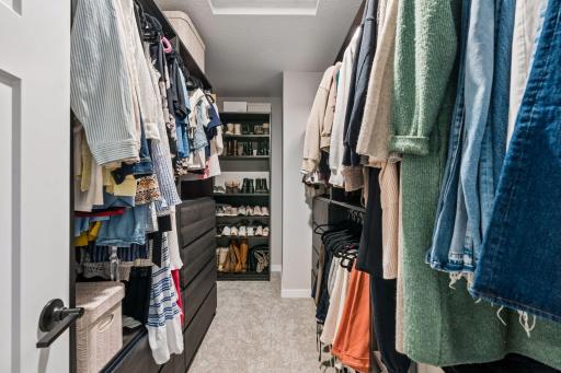 Huge primary walk-in closet with custom organizers.
