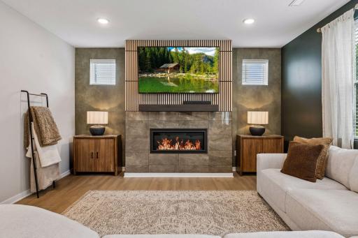 Lovely gas fireplace upgraded tile surround, wood mantle, and wood slat wall panel.