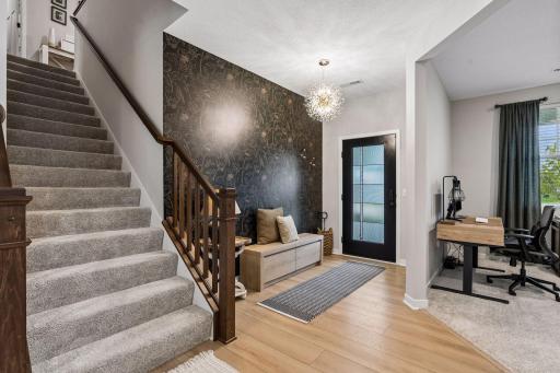 Foyer, open stair case, and office/formal dining room.
