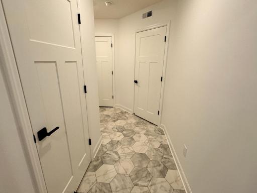 Lever Lock Door handles throughout the home and this is the door to the main floor half bath on the way to the garage