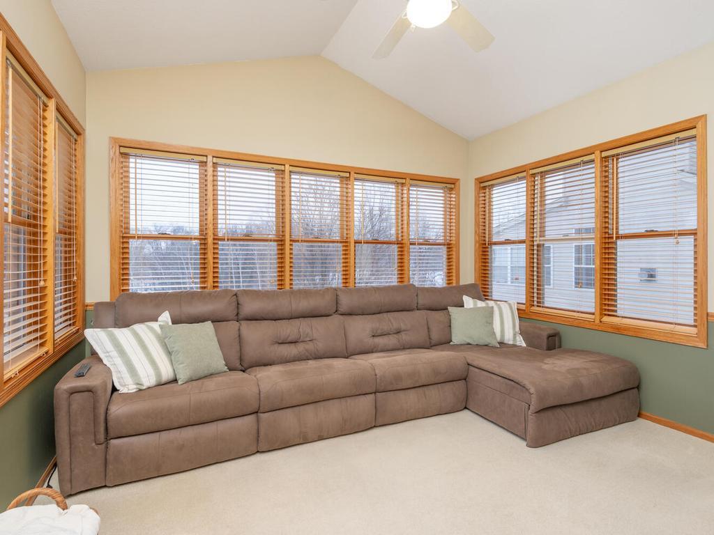Vaulted Four-Season Porch opens out to the deck with amazing views overlooking the backyard and wetlands!