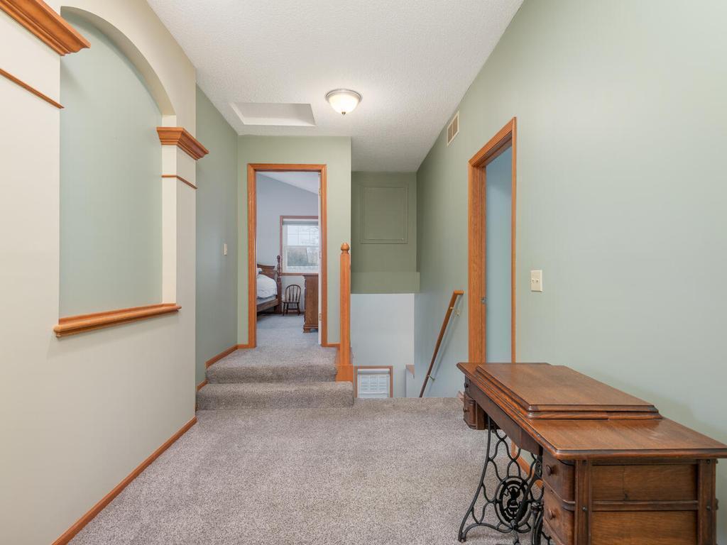 Upper level hallway continues to showcase the architectural detailing throughout the home!