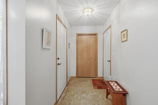Front door on left; Closet in middle; Garage entrance on right