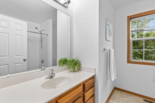 Bedrooms two and three share a full bathroom with a single vanity and tub/shower combination.