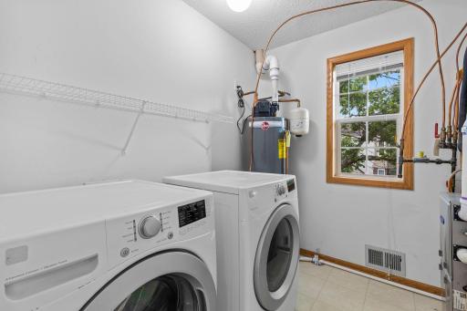 A convenient central laundry room with front-loading washer and dryer is located nearby.